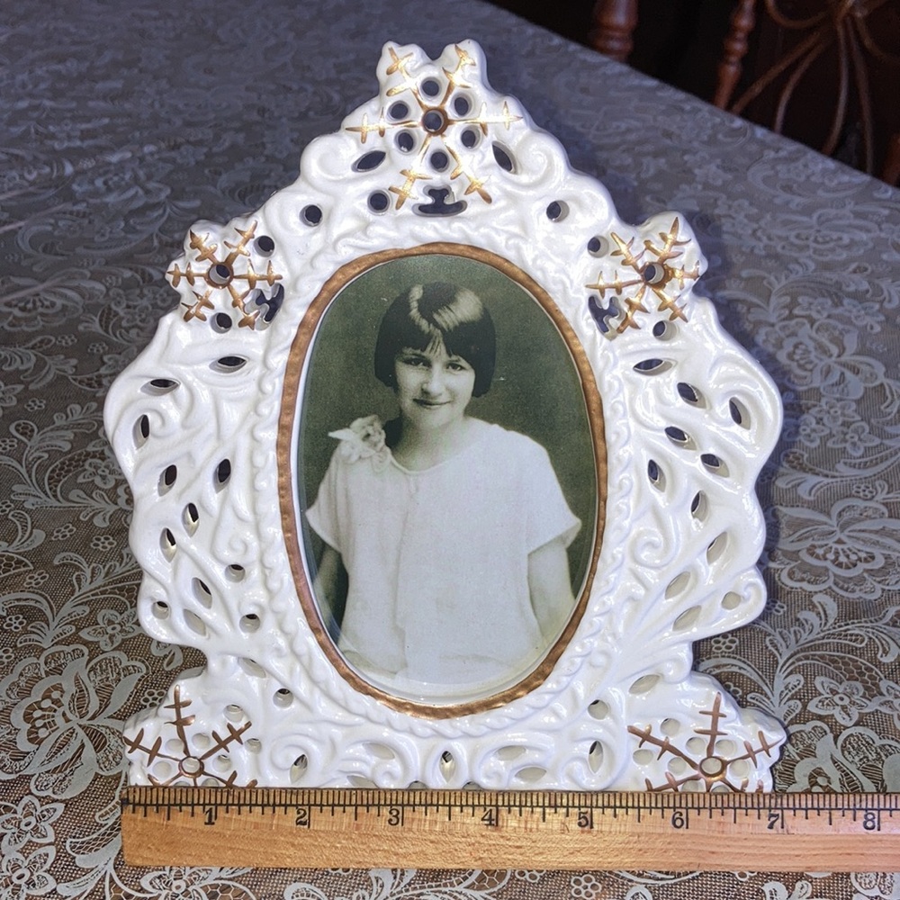 Ceramic cut/out frame wh. w/gold snowflakes fancy design in box. $9